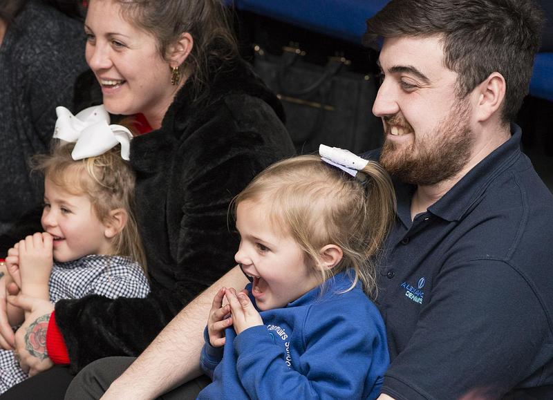 Family watching an author event